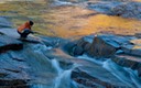 Boy playing at Waterfall