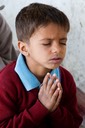 India-Young boy in prayer
